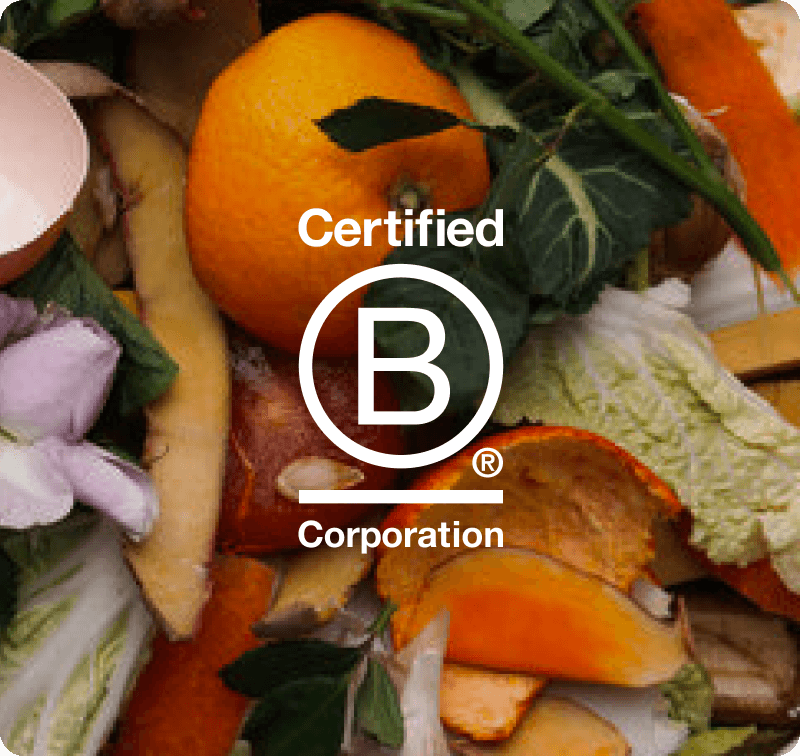 orbisk-certified-b-corporation-food-waste Certified B Corporation-badge over een stapel voedselresten